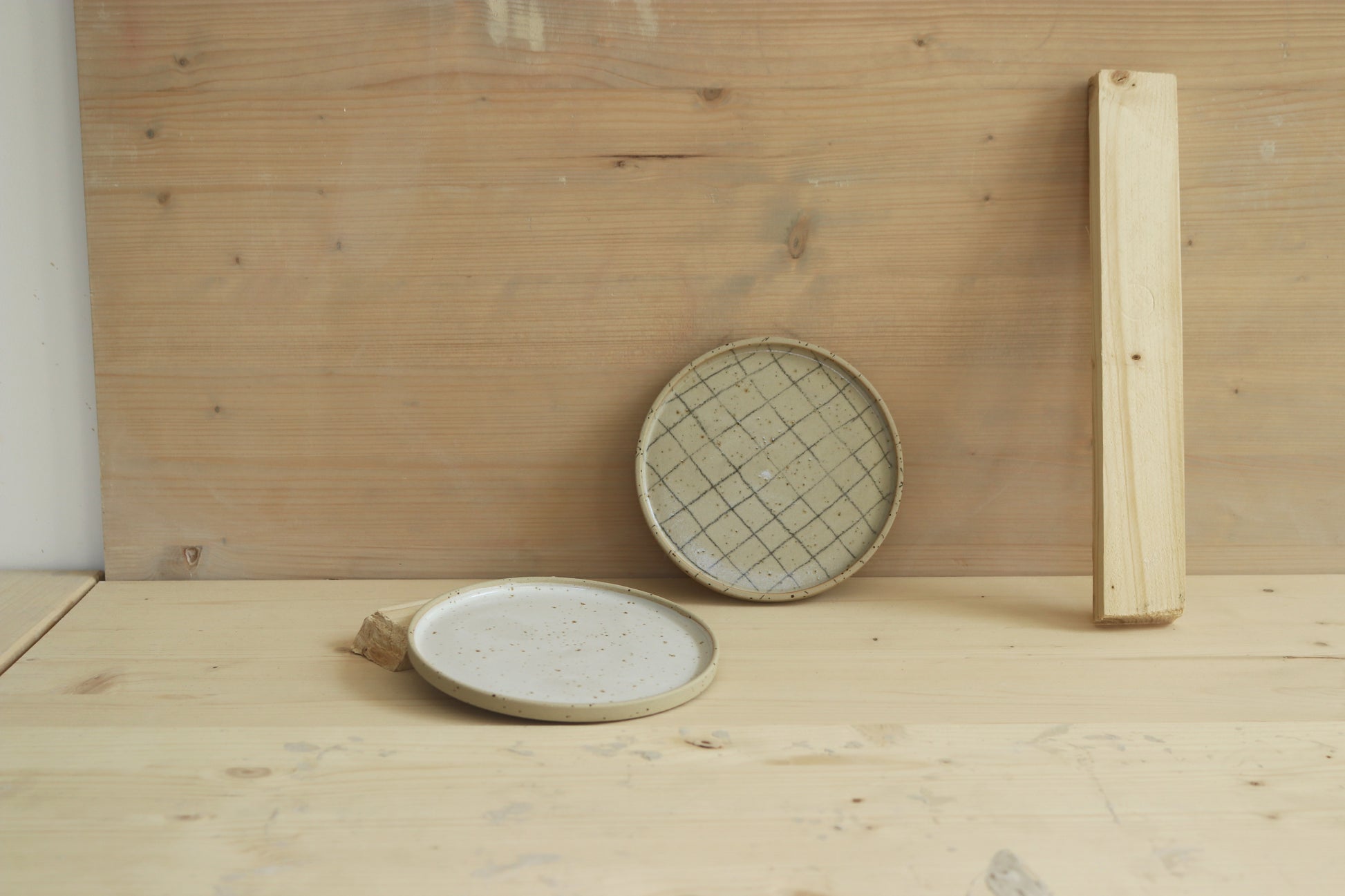 Handmade speckled stoneware ceramic snack plates: in grid pattern and covered in clear glaze and in white satin glaze. Made with lots of love in Lithuania.